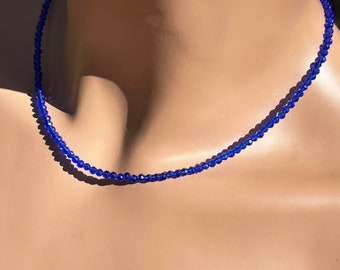 May include: A blue gemstone necklace made of small, faceted beads. The necklace is on a mannequin's neck. The text "Style 2 All Spinel" is visible below the necklace.