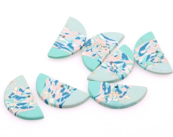 May include: A set of six half-circle ceramic buttons with a marbled design in shades of blue, pink, and white with gold flecks.
