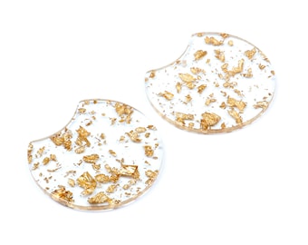 May include: Two clear round resin coasters with gold leaf flakes embedded inside. The coasters have a slightly curved edge.