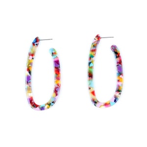 May include: A pair of colorful oval hoop earrings. The earrings feature a speckled pattern with shades of red, yellow, blue, green, and purple. The earrings are set against a white background.