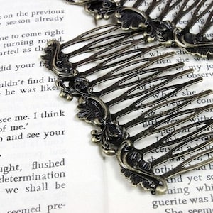 May include: Two antique gold hair combs with ornate floral designs. The combs have a decorative, vintage look and are perfect for adding a touch of elegance to any hairstyle.