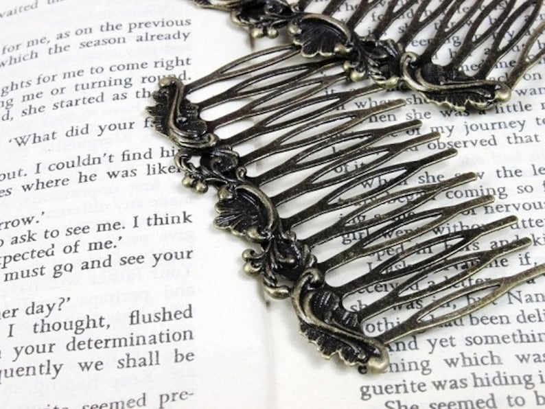 May include: Two antique gold hair combs with ornate floral designs. The combs have a decorative, vintage look and are perfect for adding a touch of elegance to any hairstyle.