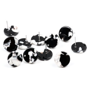 May include: Ten black and white round earrings with silver posts. The earrings have a marbled pattern.