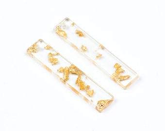 May include: Two clear rectangular resin charms with gold leaf flakes embedded inside. The charms have a hole at the top for hanging.
