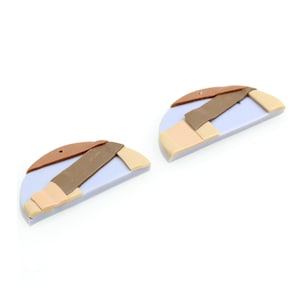 May include: Two half-circle shaped earrings made of polymer clay. The earrings are a light purple color with brown, beige, and dark brown geometric shapes.
