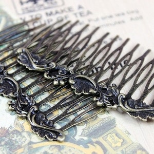 May include: A set of six antique gold hair combs with ornate floral designs. Each comb has a decorative flourish at the end.