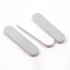 May include: Three nail files, two are white and one is light grey. The files are rectangular and have a rough surface.