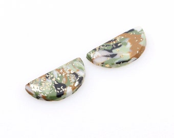 May include: Two half-circle shaped ceramic earrings with a green, brown, black, and gold marbled pattern.