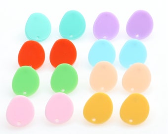 May include: Assortment of 12 colorful, flat, oval-shaped acrylic earrings with a hole in the center. The earrings are in shades of blue, green, orange, pink, yellow, and purple.
