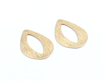 May include: Two gold-colored metal teardrop-shaped earring blanks with a textured surface and a hole at the top.