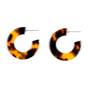 May include: A pair of brown and black tortoise shell hoop earrings. The earrings are made of a smooth, glossy material and have a simple, elegant design.