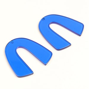 May include: Two blue acrylic arch shapes with a hole at the top for hanging.