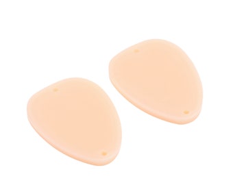 May include: Two light peach-colored, oval-shaped, plastic ear molds with a small hole in the center of each.