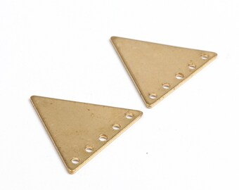May include: Two gold-colored triangle-shaped metal pieces with five holes each.