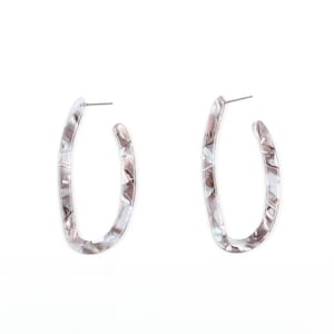 May include: A pair of oval-shaped earrings with a marbled pattern in shades of gray, white, and brown. The earrings have a post closure and are set against a white background. These earrings are a stylish accessory.