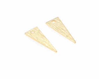 May include: Two gold triangle shaped metal charms with a small hole at the top.