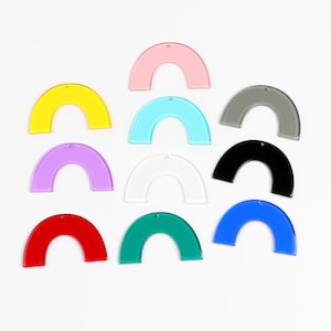 May include: Assortment of 10 colorful acrylic rainbow arch shapes. The arches are in the colors pink, yellow, light blue, purple, white, black, green, blue, and red.