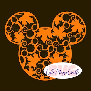 May include: An orange silhouette of a mouse head shape featuring a cut-out pattern of maple leaves and smaller mouse head outlines. An oval white label with the purple text Cute Magic Craft is positioned over the lower right section.