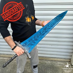 May include: A handcrafted, blue-bladed sword with etched leaf patterns. The hilt and handle are silver and black. The image includes the text "HANDCRAFTED" and "FORGED VALOR PREMIUM QUALITY".