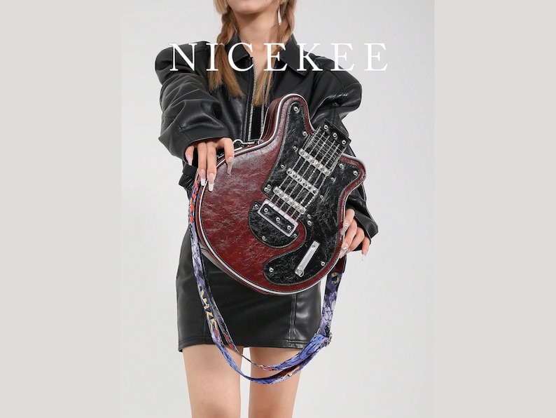May include: A burgundy and black guitar-shaped handbag with a patterned strap. The bag has silver hardware and the word "NICEKEE" in white block letters at the top. The bag is held by a person wearing a black leather jacket and skirt.