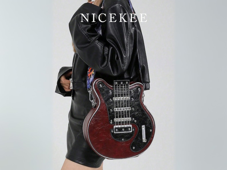 May include: A burgundy and black guitar-shaped crossbody bag with silver hardware. The bag has a guitar neck and strings design. The word "NICEKEE" is printed in white at the top. The bag is worn over the shoulder.
