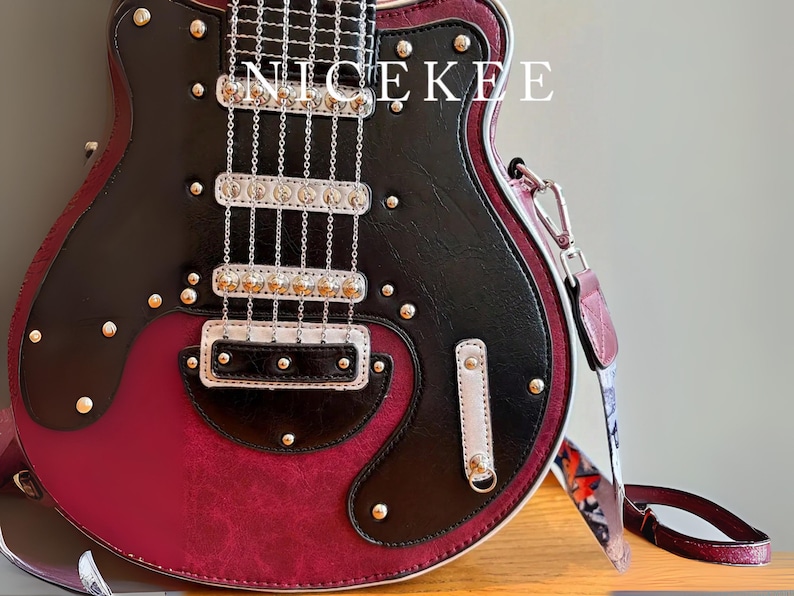 May include: A guitar-shaped handbag in black and burgundy leather with silver-tone hardware. The bag features a shoulder strap and is embellished with decorative studs. The word "NICEKEE" is printed on the top.