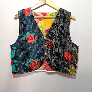 Handmade reversible Kantha embroidered vest featuring black and navy blue panels with bright floral prints and visible hand stitching