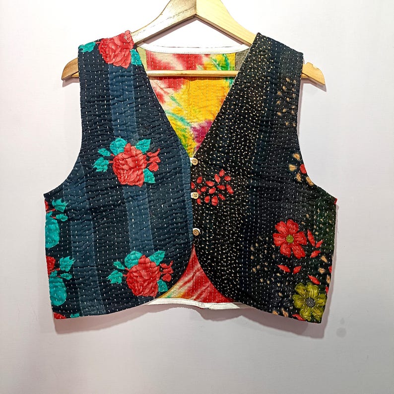 Handmade reversible Kantha embroidered vest featuring black and navy blue panels with bright floral prints and visible hand stitching