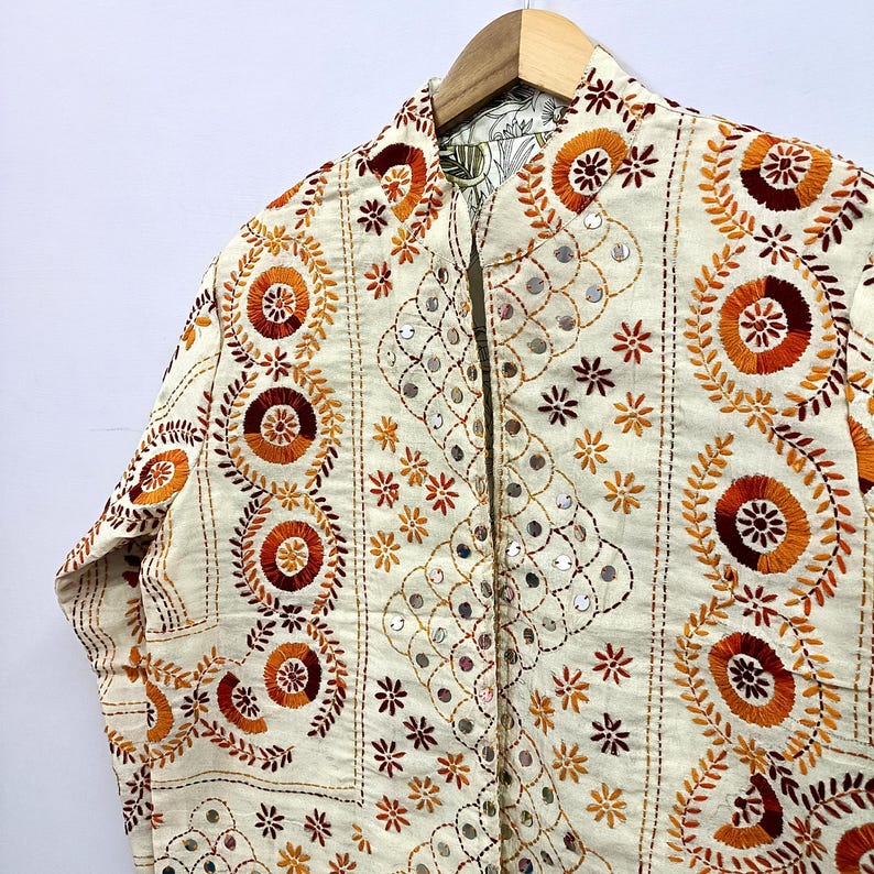 Beautiful floral motifs, geometric embroidery patterns, and handcrafted mirror accents create a rich textured look perfect for bohemian fashion lovers, festival outfits, Indo-western styling, vacation wear, casual layering, and sustainable artisan fashion collections.