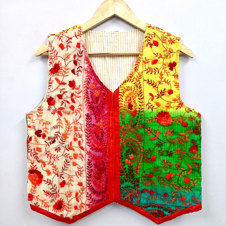 Make a bold statement with this handmade embroidered Indian vest, featuring vibrant multicolor fabric panels and beautiful floral vine embroidery.