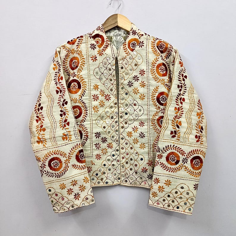 Handmade reversible cropped cotton jacket featuring intricate brown floral embroidery, delicate mirror work embellishments, and detailed artisan threadwork inspired by traditional Indian craftsmanship.