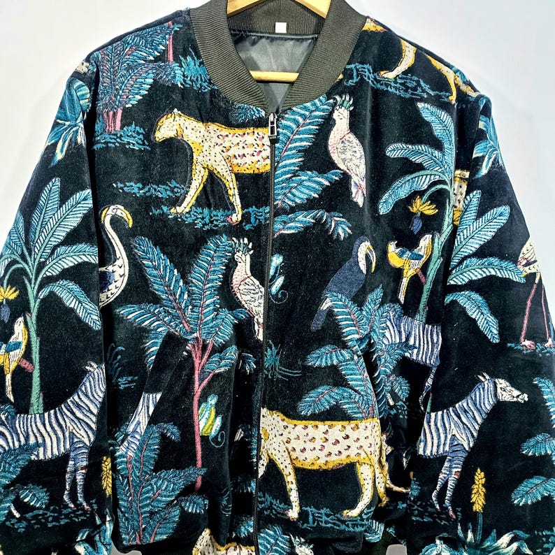 Handmade velvet kantha quilted bomber jacket with jungle animal and tropical foliage print, zip front design with ribbed collar and cuffs.