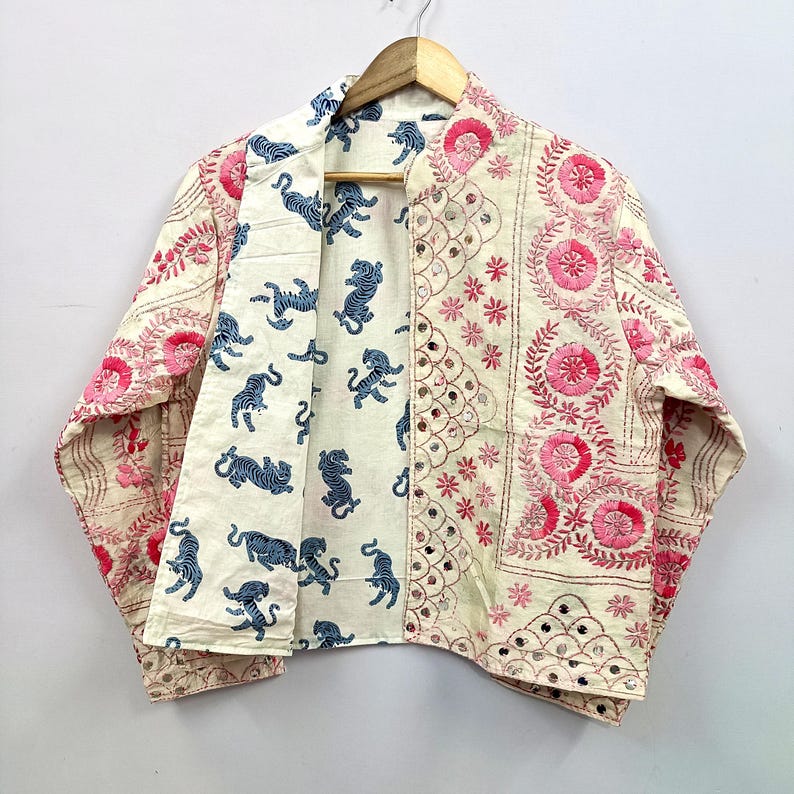The reversible wearable design provides two unique styling options in one garment, making it a versatile addition to any wardrobe.