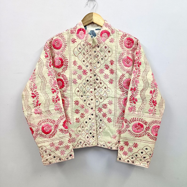 Handmade reversible cropped cotton jacket featuring intricate pink floral embroidery, delicate mirror work embellishments, and detailed artisan threadwork inspired by traditional Indian craftsmanship.