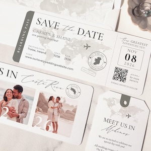 May include: Wedding invitation suite featuring a boarding pass design with the text "Save the Date" and a world map graphic. Includes a photo card and a tag with the text "Meet us in Mykonos". The color scheme is primarily white and gray.