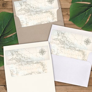May include: Two white envelopes with a vintage map of the Caribbean Sea printed on them. The map features a compass rose and the text "Atlantic Ocean" and "Caribbean Sea".
