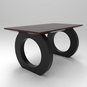 May include: A rectangular table with a dark brown wooden top and two black circular bases. The table features a flat, smooth surface and two large, solid ring-shaped supports that provide a stable foundation for the tabletop structure.