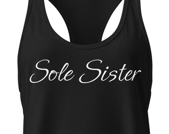 May include: Black racerback tank top with the text "Sole Sister" in a cursive font. The tank top has a scoop neck and a racerback design, suitable for athletic activities or casual wear.