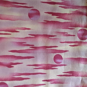 May include: Fabric with a watercolor-style design featuring pink clouds and circular shapes against a light background. The pattern has a dreamy, artistic quality, with soft color transitions and a flowing aesthetic.