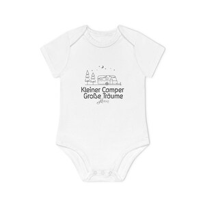 May include: White baby onesie with a black graphic of a camper, trees, and stars. The text "Kleiner Camper Gro&szlig;e Tr&auml;ume" is printed below the graphic. The onesie has short sleeves and snaps at the bottom.