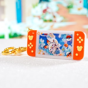 Porte clé SHAKER Switch Flambino fait main en Résine et fond carte Pokémon | Keychain resin art Scorbunny