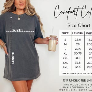 May include: A charcoal grey short-sleeve t-shirt with a Comfort Colors size chart displaying length and width measurements in inches for sizes S through 4XL. The chart includes a diagram indicating how to measure the width and length of the garment.