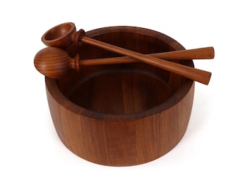 May include: A wooden salad bowl with two matching serving spoons. The bowl is round and has a dark brown finish. The spoons have a rounded end and a long handle. The set is made of wood.