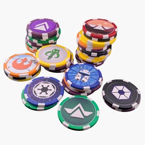 May include: A collection of round gaming chips featuring various Star Wars themed designs, including the Rebel Alliance symbol, the Imperial crest, a Mandalorian helmet, and a Clone Trooper helmet, with colorful edges and black and white checkered patterns.