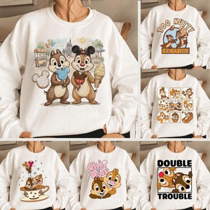 May include: White sweatshirts with various Chip and Dale designs. One features the duo with ice cream and a Mickey Mouse-shaped donut. Other designs include the text "Too Nutty," a stamp-like collage, and the phrase "Double Trouble."