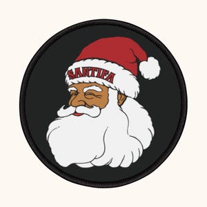 May include: Circular black patch with a cartoon Santa Claus design. The Santa wears a red hat with the word "SANTIF" on it and has a white beard. The Santa Claus is smiling.
