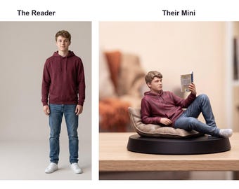 May include: A person wearing a maroon hoodie and blue jeans stands on the left. On the right, a miniature figurine of the same person in a maroon hoodie and blue jeans reclines on a tan cushion atop a black circular base, reading a small book.