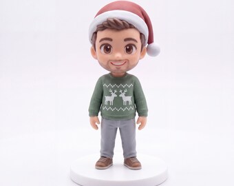 May include: A figurine of a person with brown hair wearing a red Santa hat, a green long-sleeved sweater with a white reindeer pattern, and gray pants. The figure has a smiling expression, light skin, and stands on a round white base.