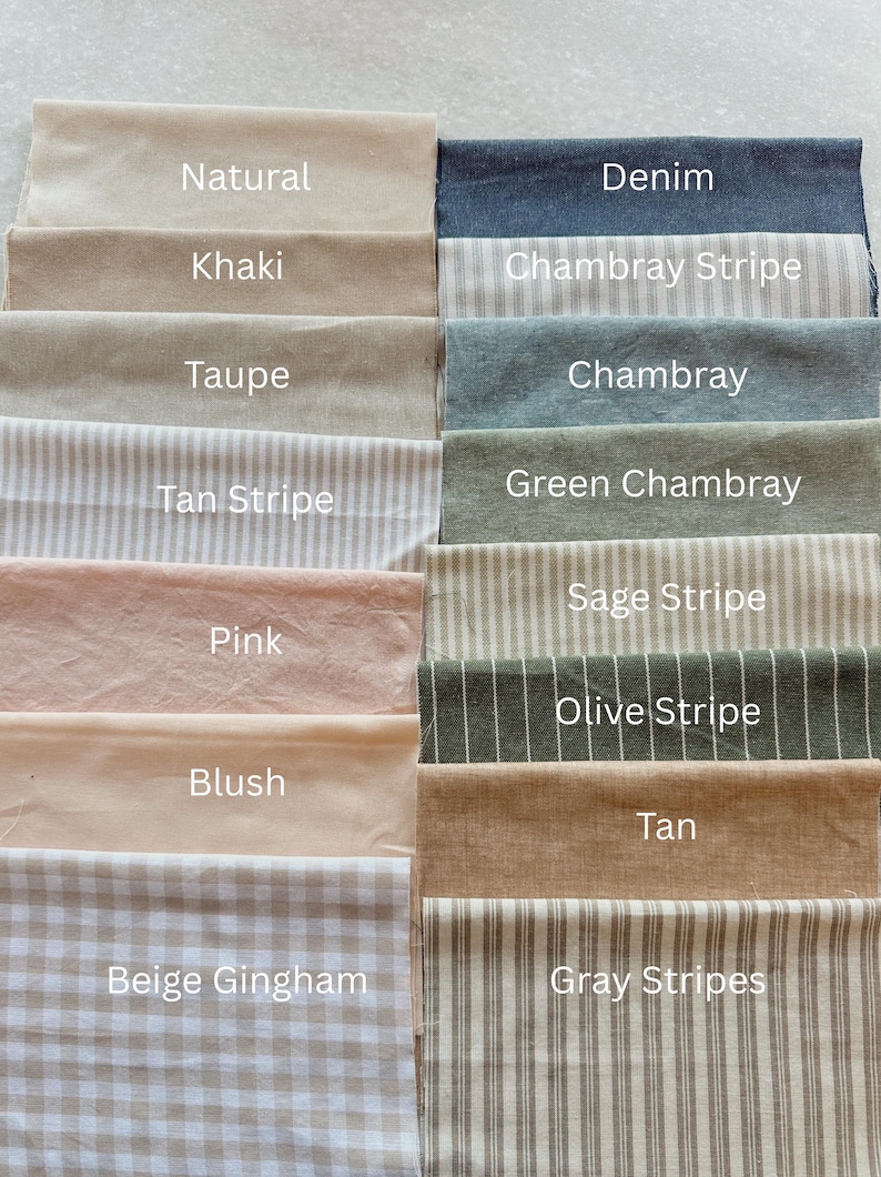 May include: A collection of fabric swatches in various colors and patterns. Colors include natural, khaki, taupe, pink, blush, tan, and denim. Patterns include stripes, gingham, and chambray. Each swatch is labeled with its color or pattern name.