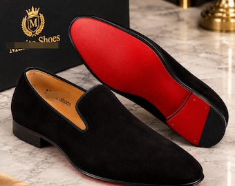 Christian Louboutin Dandelion black suede loafers featuring the signature red sole.